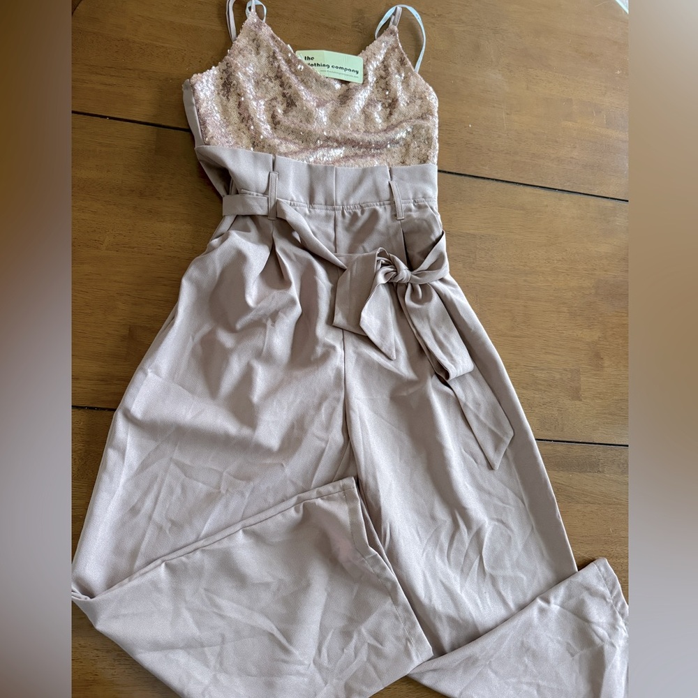 Jumpsuit/romper Rose gold top with tan bottoms.